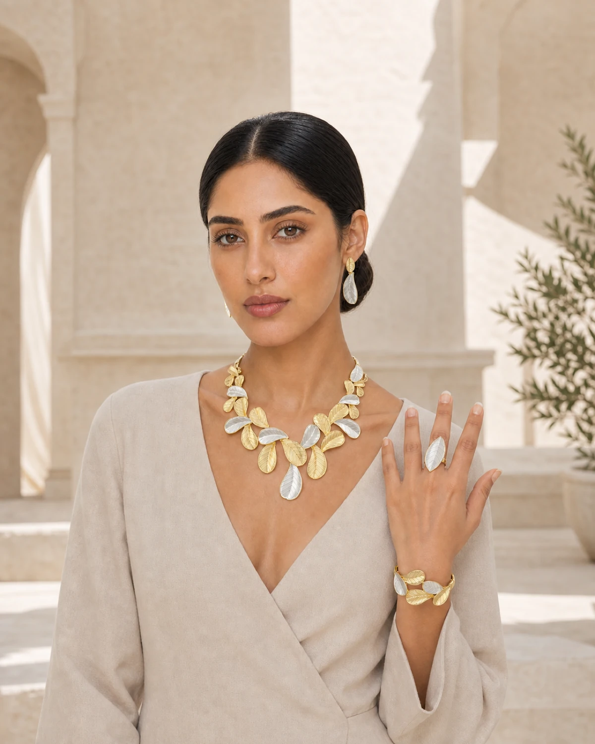 Model wearing the complete Cassia jewellery set in warm architectural light.